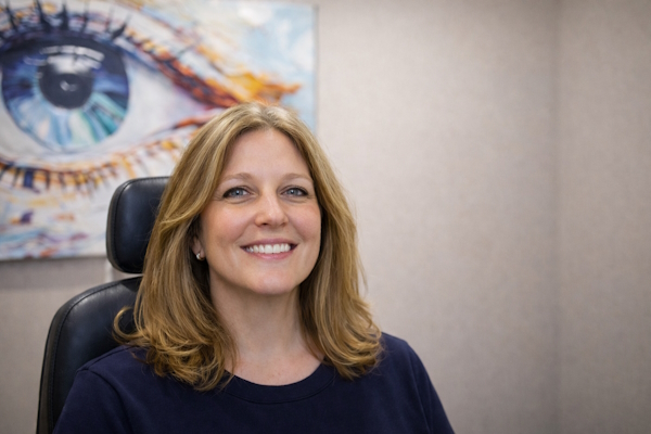 Woman smiling after IPL treatment for ocular aesthetics with clearer skin and brighter eyes in Baltimore eye care practice